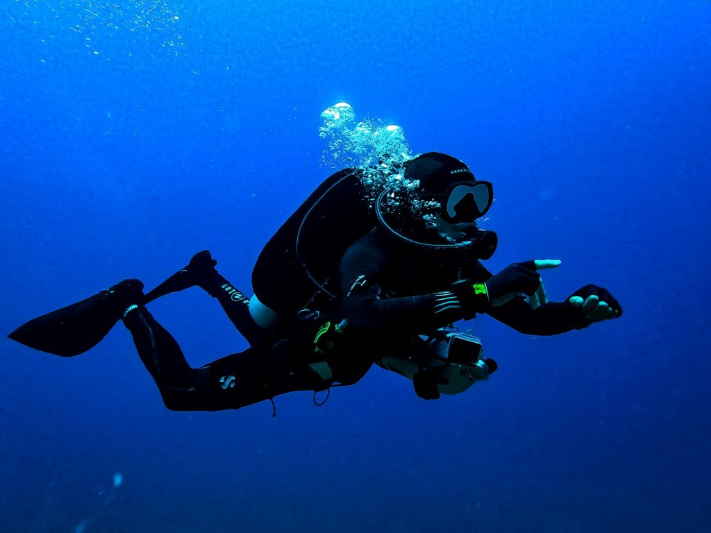 Scuba diver in blue water